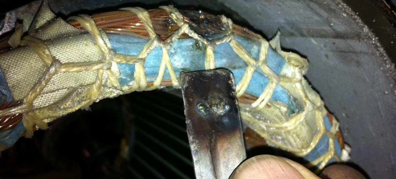 Figure 9. Clockwise from top left: broken cast aluminum fan, piece of fan and set screw, grounded windings